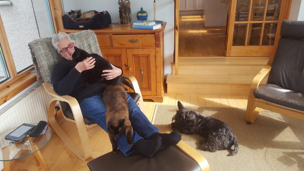 Ros enjoying hanging out with animals while house sitting in Scotland.