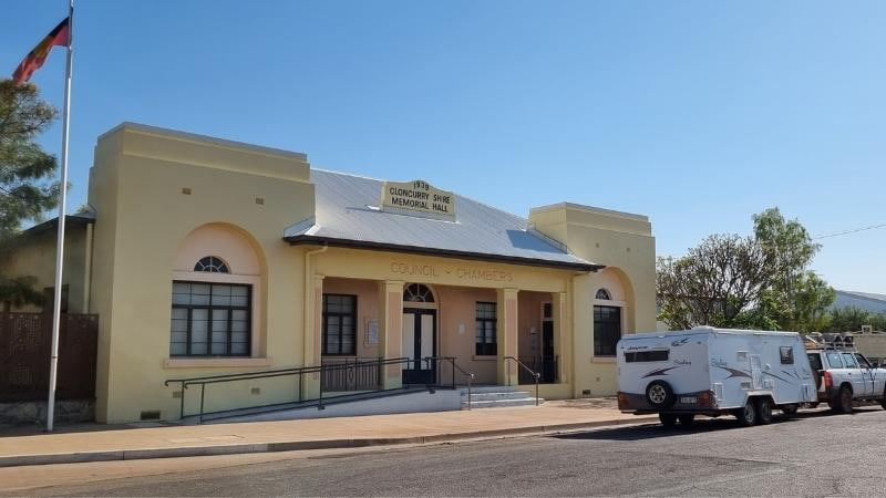 Darwin to Cairns road trip Cloncurry Shire Memorial Hall and Council Chambers, a heritage-style government building with flagpole and parked caravan in Cloncurry, north-west Queensland