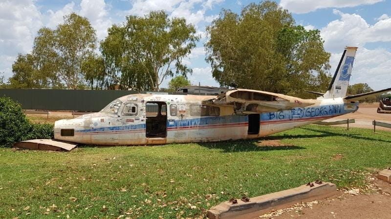 Darwin to Cairns road trip Rusting aircraft fuselage known as “Big Lizzie Georgina” displayed on the grass at Daly Waters, a quirky roadside attraction in the Northern Territory
