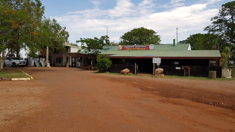 Darwin to Cairns road trip Remote roadhouse at Renner Springs Desert Inn, surrounded by red dirt and trees, a common stop along the Stuart Highway in the Northern Territory
