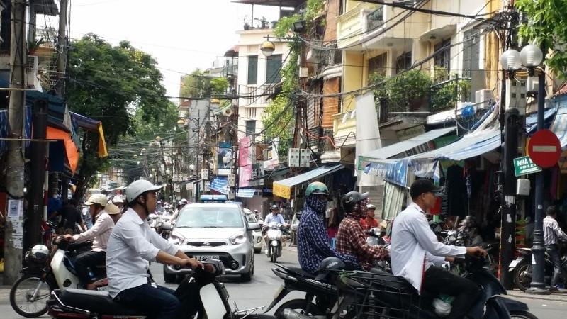 Crossing the street in Hanoi can be daunting. Just remember that traffic doesn't stop at crossings and try to cross the road in Vietnam with a local