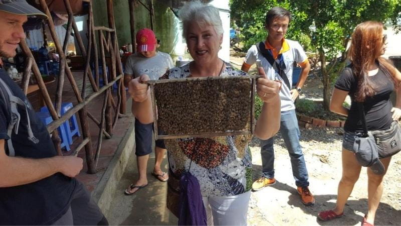 Ros holding Bees on a tour of the Mekong Delta