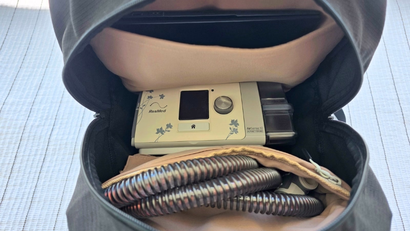 ResMed CPAP travel bags ResMed AirSense CPAP machine and hose packed inside a Luxe travel backpack alongside a laptop