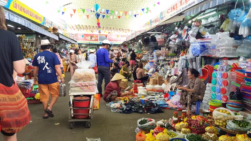 Long Stays in Vietnam Locals and tourists shopping at the busy Com Market in Da Nang, Vietnam with stalls selling spices, produce and household goods